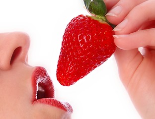 Image showing Woman with strawberry on her red lips