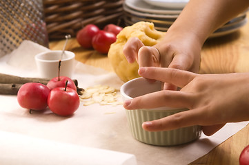 Image showing Detail of child hands making apple pie