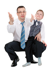 Image showing businessman and his son pulled his hands in the studio
