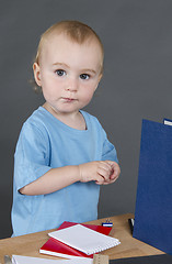 Image showing young child at small desk