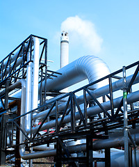 Image showing industrial pipelines and smokestack with a natural blue backgrou