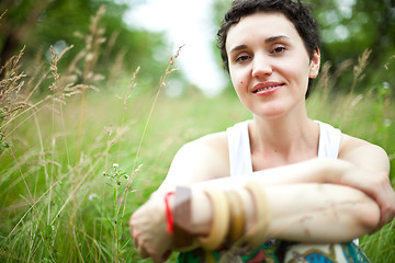 Image showing cute girl on green field 