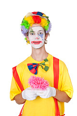 Image showing Clown holding pink flower