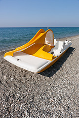 Image showing Yellow catamaran on a beach