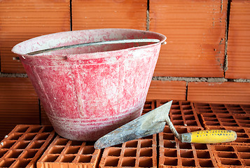 Image showing Trowel, bucket and bricks