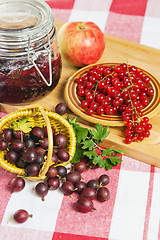 Image showing Jam with berries of red currant and gooseberry on the table