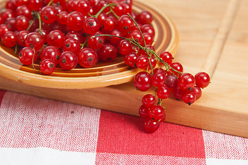 Image showing Berries of a red currant in a plate on a table