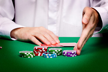 Image showing men's hands, playing cards and chips
