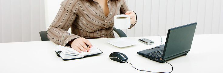 Image showing woman drinking coffee at work with