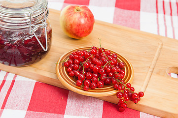 Image showing Jam with berries of a red currant on a table.