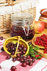 Image showing Jam with berries of red currant and gooseberry on the table