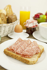 Image showing tasty breakfast with salami toast on table