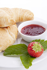 Image showing deliscios fresh croissant with strawberry jam isolated