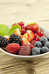 Image showing fresh tasty berry collection on table in summer