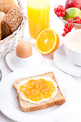 Image showing breakfast table with toast and orange marmelade isolated