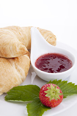 Image showing deliscios fresh croissant with strawberry jam isolated