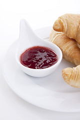 Image showing deliscios fresh croissant with strawberry jam isolated