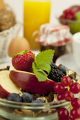 Image showing tasty breakfast with flakes and fruits in morning