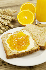 Image showing tasty breackfast with toast and marmelade on table