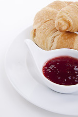 Image showing deliscios fresh croissant with strawberry jam isolated