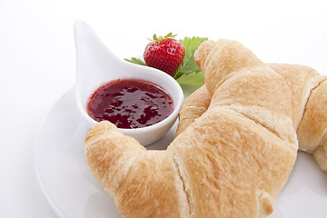 Image showing deliscios fresh croissant with strawberry jam isolated