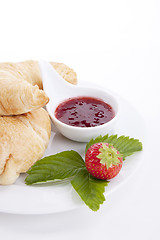 Image showing deliscios fresh croissant with strawberry jam isolated