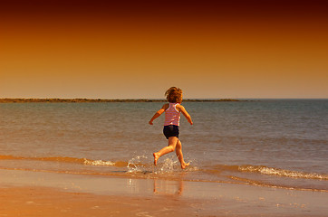 Image showing Girl running on the beach