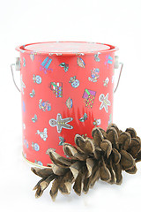 Image showing Christmas tin with pine cone