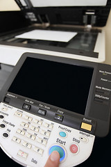 Image showing Finger pressing of keyboard buttons of the laser copier