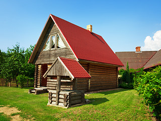 Image showing wooden house and well in the yard