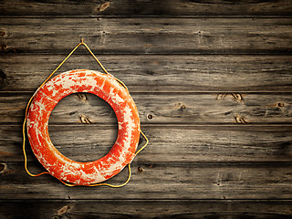 Image showing lifebuoy at wooden background