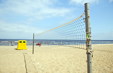Image showing Volleyball net sea waste bin boat people relax 
