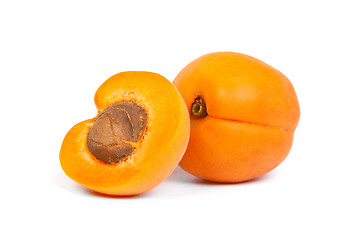 Image showing Two ripe apricot sectioned by knife