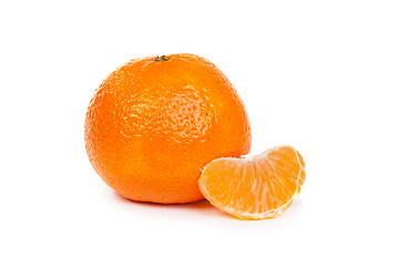 Image showing Ripe tangerine or mandarin with slices on white