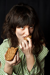 Image showing beggar woman eating bread 