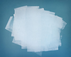 Image showing White paint. Brushstrokes on blue wall