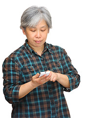 Image showing middleage woman looking on phone