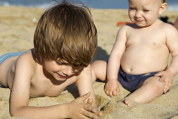 Image showing Brother and baby girl sister enjoying beach