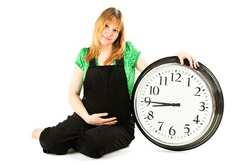 Image showing pregnant woman with a clock 