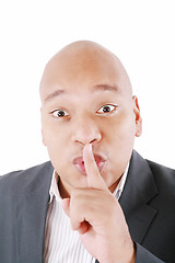 Image showing Black man showing silence gesture with finger on his lips. All o