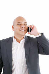 Image showing A smiling African American business man talking on cellphone ove