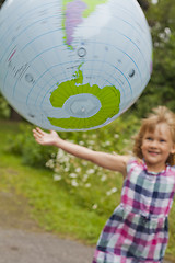 Image showing Girl throwing an earth globe