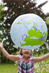 Image showing Girl throwing an earth globe