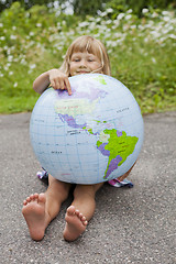 Image showing Girl holding an earth globe