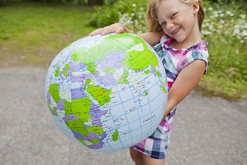 Image showing Girl holding an earth globe