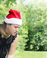Image showing Cute woman wearing santa hat