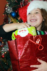 Image showing Pretty girl opening Christmas package