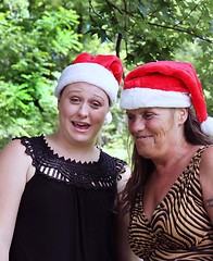 Image showing Two women wearing Santa hats