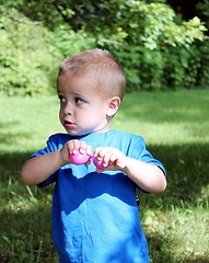 Image showing Little boy in blue with Easter candy