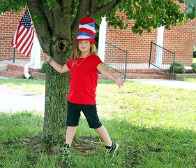 Image showing Pretty girl waving flag for the 4th of July
